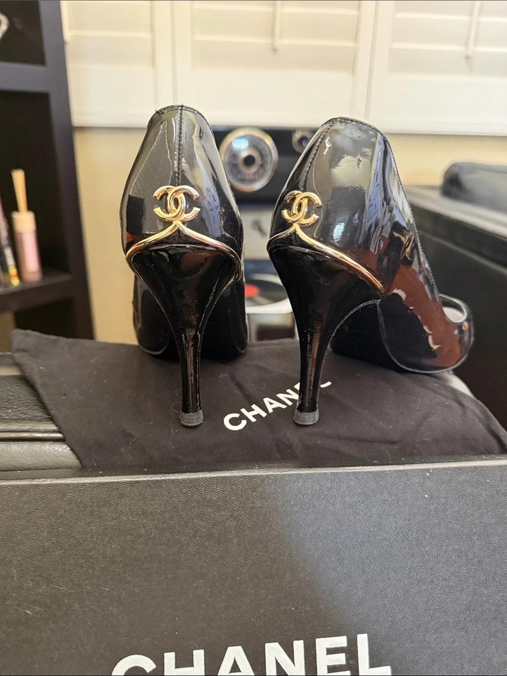 CHANEL Black Patent Peep-Toe Stiletto Pumps with Gold CC Heel Accent
